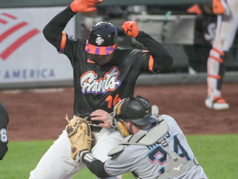 Jun 24, 2025; San Francisco, California, USA;  San Francisco Giants designated hitter Rafael Devers (16) is tagged out at home plate by Miami Marlins catcher Liam Hicks (34) during the sixth inning at Oracle Park. Mandatory Credit: Ed Szczepanski-Imagn Images