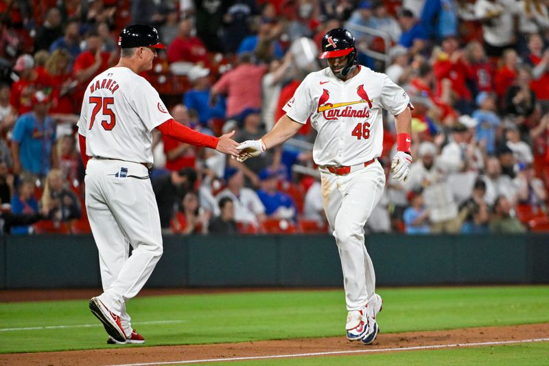 May 26, 2024; St. Louis, Missouri, USA;  St. Louis Cardinals first baseman Paul Goldschmidt (46) is congratulated by third base coach Ron 'Pop' Warner (75) after hitting a two run home run off against the Chicago Cubs during the fifth inning at Busch Stadium. Mandatory Credit: Jeff Curry-USA TODAY Sports