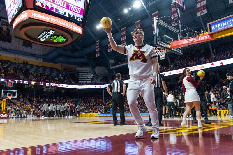 Jan 19, 2023; Minneapolis, Minnesota, USA; the Minnesota Golden Gophers cheerleaders throw mini basketballs to fans during the first half against the Purdue Boilermakers at Williams Arena. Mandatory Credit: Matt Blewett-USA TODAY Sports