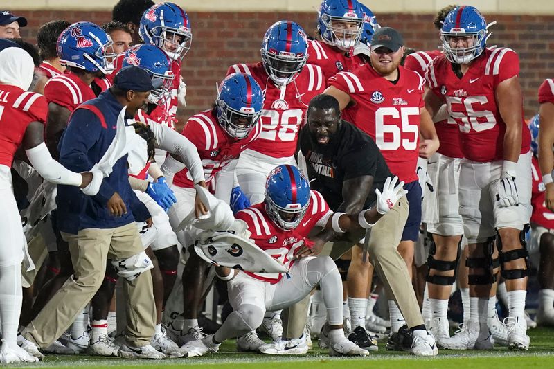 Sep 18, 2021; Oxford, Mississippi, USA; The Mississippi Rebels celebrate on the sideline during the game against Tulane Green Wave  at Vaught-Hemingway Stadium. Mandatory Credit: Marvin Gentry-USA TODAY Sports