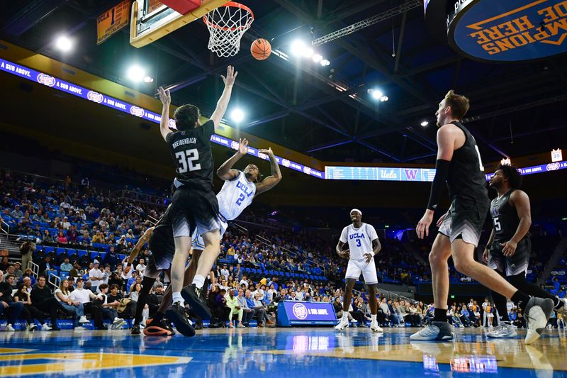 January 14, 2024; Los Angeles, California, USA; UCLA Bruins guard Dylan Andrews (2) shoots against Washington Huskies forward Wilhelm Breidenbach (32) during the second half at Pauley Pavilion. Mandatory Credit: Gary A. Vasquez-USA TODAY Sports