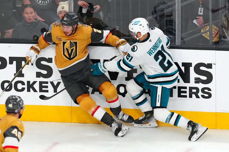 Oct 26, 2024; Las Vegas, Nevada, USA; San Jose Sharks center Alexander Wennberg (21) checks Vegas Golden Knights center Brett Howden (21) during the third period at T-Mobile Arena. Mandatory Credit: Stephen R. Sylvanie-Imagn Images