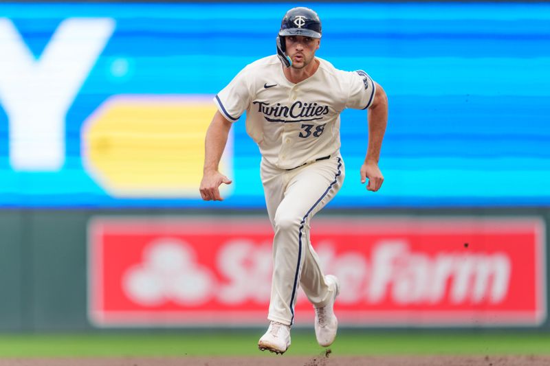 Sep 24, 2023; Minneapolis, Minnesota, USA; Minnesota Twins designated hitter Matt Wallner (38) runs to third base and then home on a single by shortstop Kyle Farmer (12) in the seventh inning against the Los Angeles Angels. Mandatory Credit: Matt Blewett-USA TODAY Sports