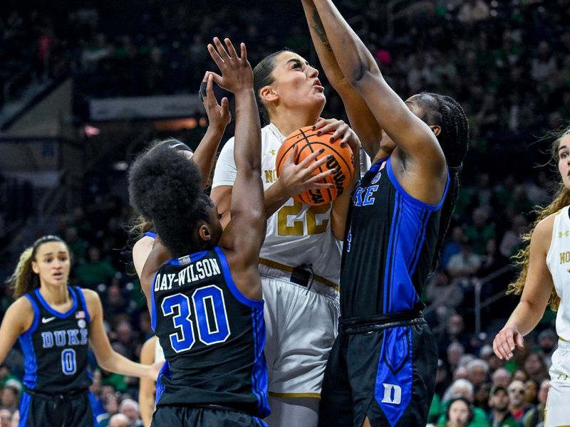 Feb 5, 2023; South Bend, Indiana, USA; Notre Dame Fighting Irish forward Kylee Watson (22) goes up for a shot as Duke Blue Devils gaurd Shayeann Day-Wilson (30) and guard Elizabeth Balogun (4) defend in the second half at the Purcell Pavilion. 