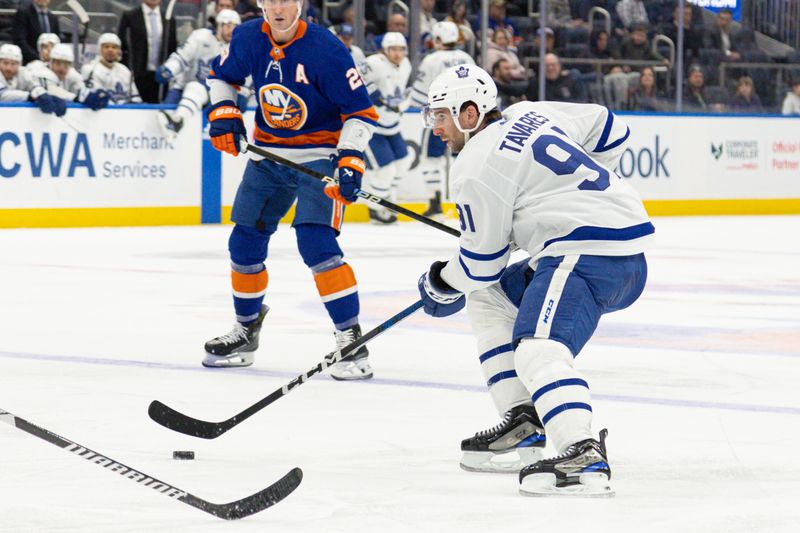 Dec 11, 2023; Elmont, New York, USA; Toronto Maple Leafs center John Tavares (91) moves the puck against the New York Islanders during the third period at UBS Arena. Mandatory Credit: Thomas Salus-USA TODAY Sports