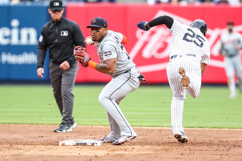 May 4, 2024; Bronx, New York, USA;  Detroit Tigers second base Andy Ibáñez (77) collides with New York Yankees second baseman Gleyber Torres (25) attempting to turn a double play in the sixth inning at Yankee Stadium. Mandatory Credit: Wendell Cruz-USA TODAY Sports