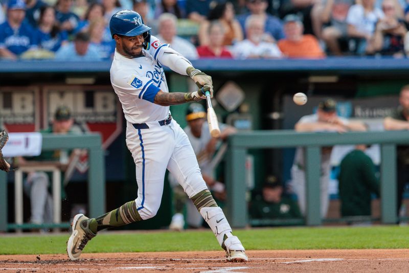 May 18, 2024; Kansas City, Missouri, USA; Kansas City Royals third base Maikel Garcia (11) gets a base hit during the first inning against the Oakland Athletics at Kauffman Stadium. Mandatory Credit: William Purnell-USA TODAY Sports