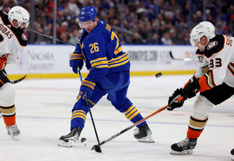 Feb 19, 2024; Buffalo, New York, USA;  Buffalo Sabres defenseman Rasmus Dahlin (26) deflects the puck past Anaheim Ducks right wing Jakob Silfverberg (33) during the second period at KeyBank Center. Mandatory Credit: Timothy T. Ludwig-USA TODAY Sports