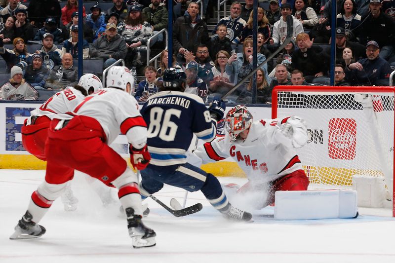 Feb 29, 2024; Columbus, Ohio, USA; Carolina Hurricanes goalie Spencer Martin (41) makes a blocker save from the shot of Columbus Blue Jackets right wing Kirill Marchenko (86) during the third period at Nationwide Arena. Mandatory Credit: Russell LaBounty-USA TODAY Sports