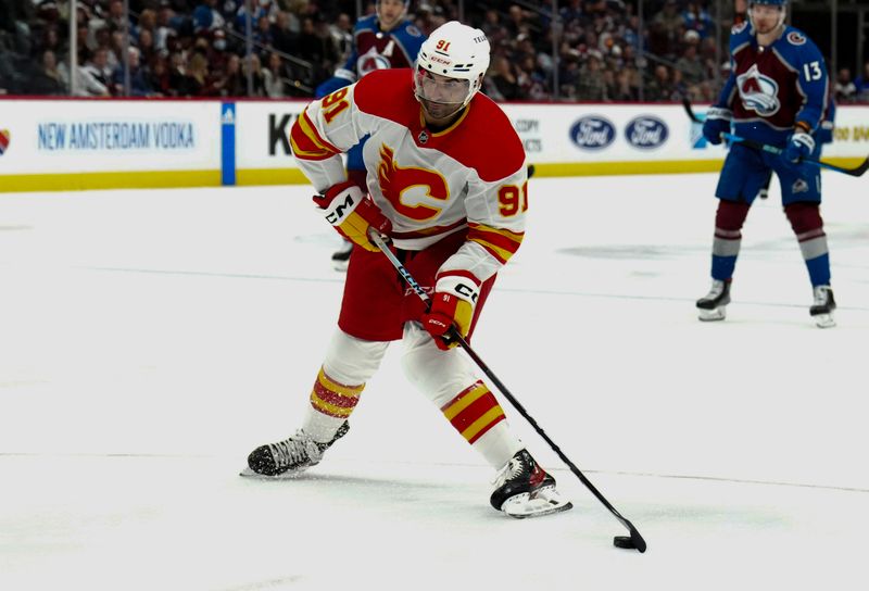 Dec 11, 2023; Denver, Colorado, USA; Calgary Flames center Nazem Kadri (91) prepares to shoot the puck in the third period against the Colorado Avalanche at Ball Arena. Mandatory Credit: Ron Chenoy-USA TODAY Sports