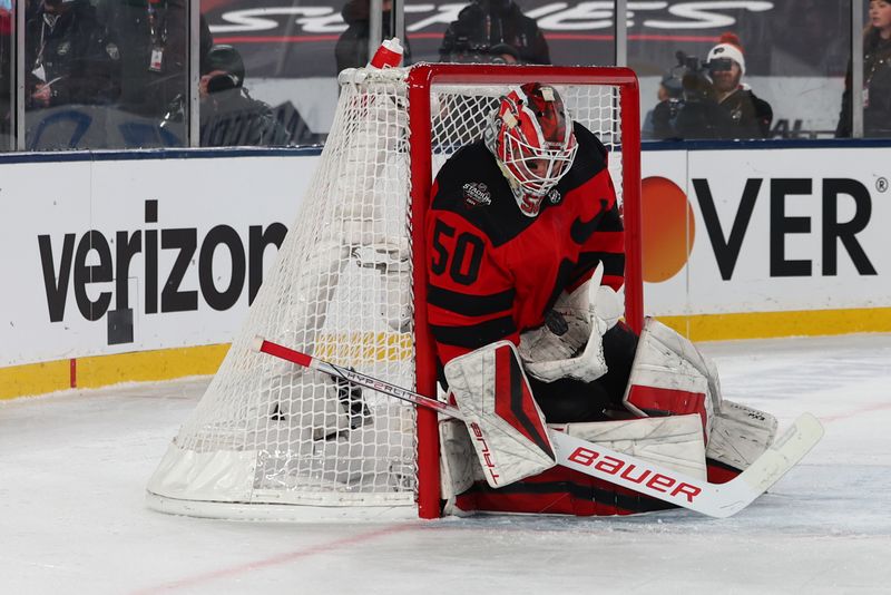 Feb 17, 2024; East Rutherford, New Jersey, USA; New Jersey Devils goaltender Nico Daws (50) makes a save against the Philadelphia Flyers during the first period in a Stadium Series ice hockey game at MetLife Stadium. Mandatory Credit: Ed Mulholland-USA TODAY Sports