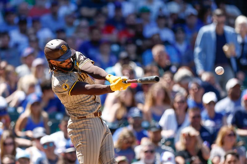 May 8, 2024; Chicago, Illinois, USA; San Diego Padres outfielder Fernando Tatis Jr. (23) hits an RBI-single against the Chicago Cubs during the fifth inning at Wrigley Field. Mandatory Credit: Kamil Krzaczynski-USA TODAY Sports