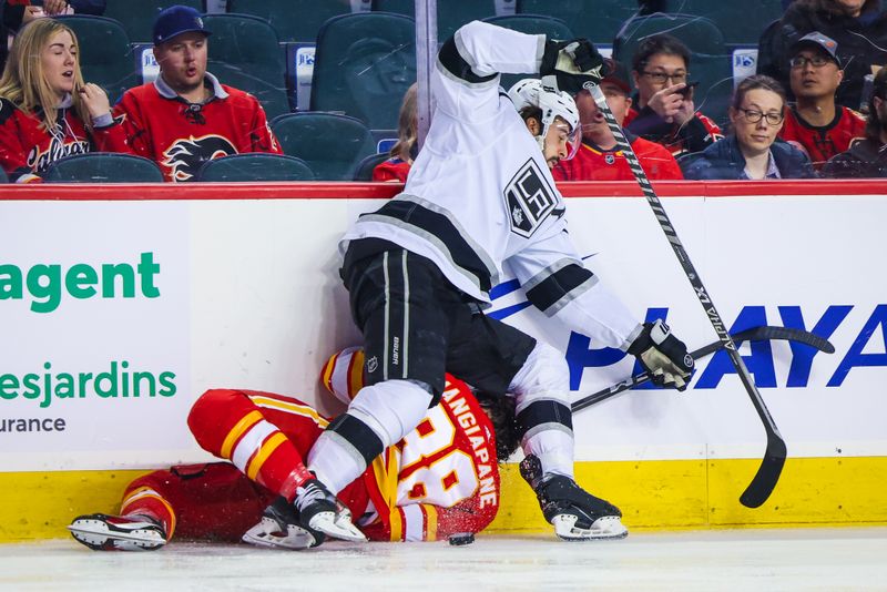 Mar 28, 2023; Calgary, Alberta, CAN; Los Angeles Kings center Phillip Danault (24) and Calgary Flames left wing Andrew Mangiapane (88) battle for the puck during the first period at Scotiabank Saddledome. Mandatory Credit: Sergei Belski-USA TODAY Sports