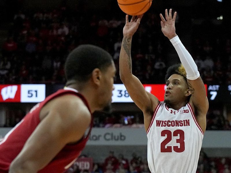 Jan 6, 2024; Madison, Wisconsin, USA; Wisconsin guard Chucky Hepburn (23) attempts a three-point basket during the second half of their game at Kohl Center. Mandatory Credit: Mark Hoffman-USA TODAY Sports