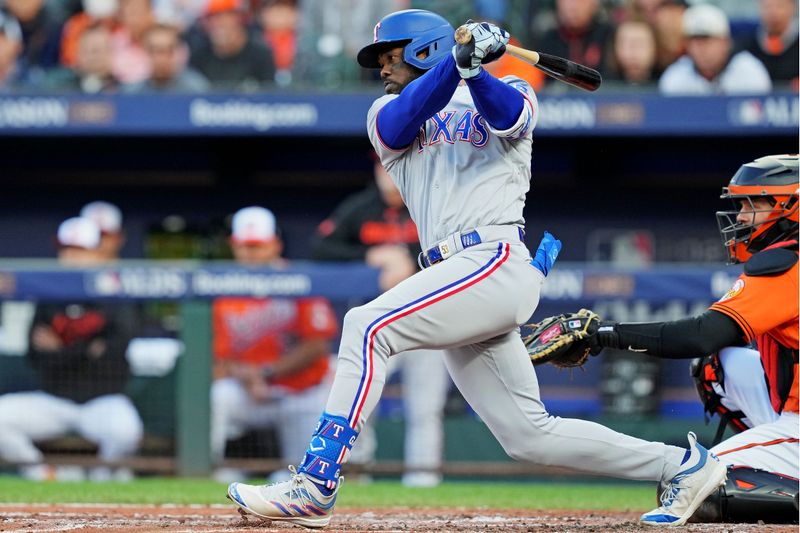 Oct 8, 2023; Baltimore, Maryland, USA; Texas Rangers right fielder Adolis Garcia (53) hits an RBI single during the second inning against the Baltimore Orioles during game two of the ALDS for the 2023 MLB playoffs at Oriole Park at Camden Yards. Mandatory Credit: Mitch Stringer-USA TODAY Sports