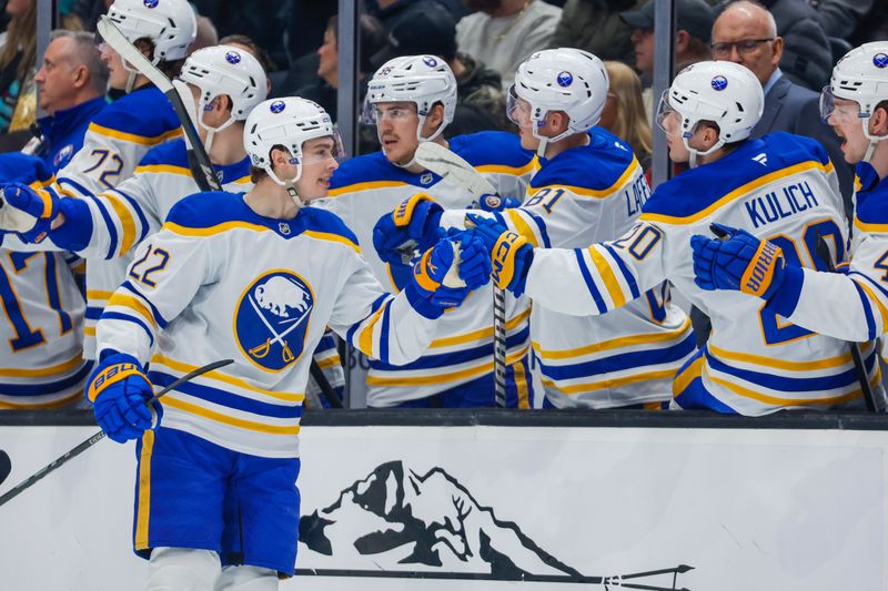 Jan 20, 2025; Seattle, Washington, USA; Buffalo Sabres right wing Jack Quinn (22) high -ives teammates on the bench after scoring a goal against the Seattle Kraken during the first period at Climate Pledge Arena. Mandatory Credit: Joe Nicholson-Imagn Images