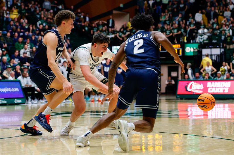 Jan 23, 2026; Fort Collins, Colorado, USA; Utah State Aggies guard Mason Falslev (12) knocks the ball away from Colorado State Rams forward Kyle Jorgensen (35) as guard MJ Collins Jr. (2) looks on in the second half at Moby Arena. Mandatory Credit: Isaiah J. Downing-Imagn Images