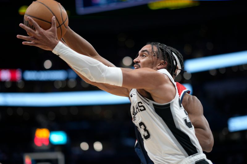 WASHINGTON, DC - JANUARY 20: Tre Jones #33 of the San Antonio Spurs reaches for a rebound against Bilal Coulibaly #0 of the Washington Wizards during the second half at Capital One Arena on January 20, 2024 in Washington, DC. NOTE TO USER: User expressly acknowledges and agrees that, by downloading and or using this photograph, User is consenting to the terms and conditions of the Getty Images License Agreement. (Photo by Jess Rapfogel/Getty Images)