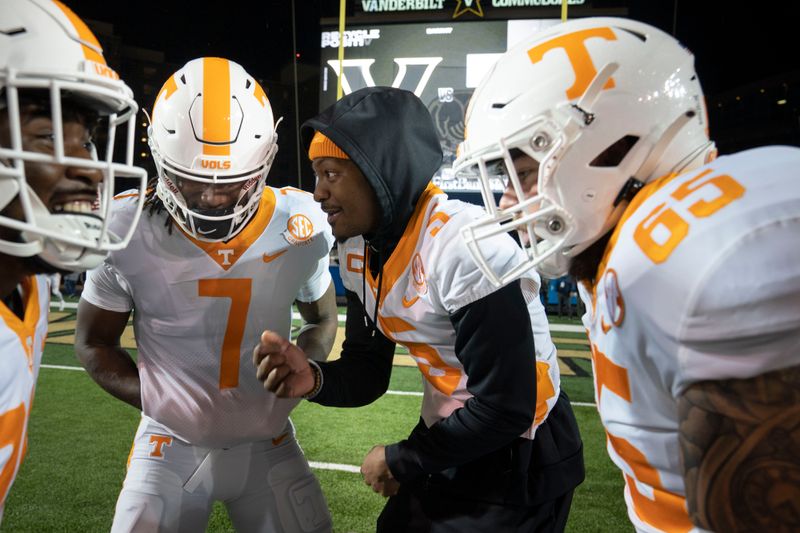 Nov 26, 2022; Nashville, Tennessee, USA;   
Tennessee Volunteers quarterback Hendon Hooker (5) talks with quarterback Joe Milton III (7) and offensive lineman Parker Ball (65) before a game against the Vanderbilt Commodores at FirstBank Stadium.  Mandatory Credit: George Walker IV - USA TODAY Sports