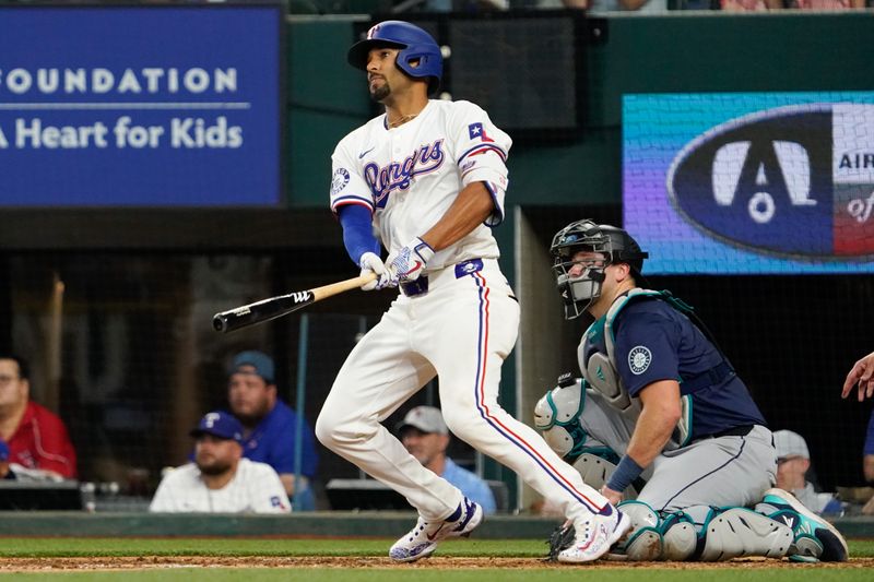 Apr 25, 2024; Arlington, Texas, USA; Texas Rangers second baseman Marcus Semien (2) hits an RBI single during the seventh inning against the Seattle Mariners at Globe Life Field. Mandatory Credit: Raymond Carlin III-USA TODAY Sports