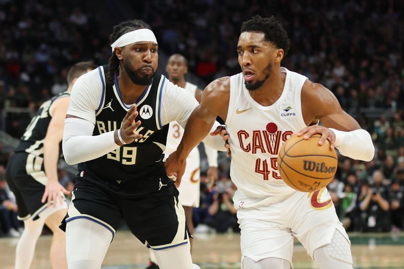 MILWAUKEE, WISCONSIN - JANUARY 26: Donovan Mitchell #45 of the Cleveland Cavaliers drives to the basket against Jae Crowder #99 of the Milwaukee Bucks during a game at Fiserv Forum on January 26, 2024 in Milwaukee, Wisconsin. NOTE TO USER: User expressly acknowledges and agrees that, by downloading and or using this photograph, User is consenting to the terms and conditions of the Getty Images License Agreement. (Photo by Stacy Revere/Getty Images)