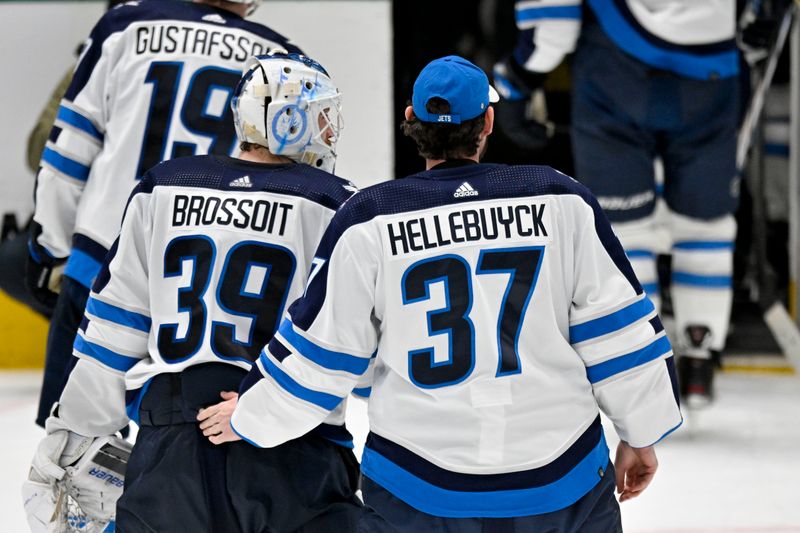 Apr 11, 2024; Dallas, Texas, USA; Winnipeg Jets goaltender Laurent Brossoit (39) and goaltender Connor Hellebuyck (37) skate off the ice after the Jets defeat the Dallas Stars at the American Airlines Center. Mandatory Credit: Jerome Miron-USA TODAY Sports