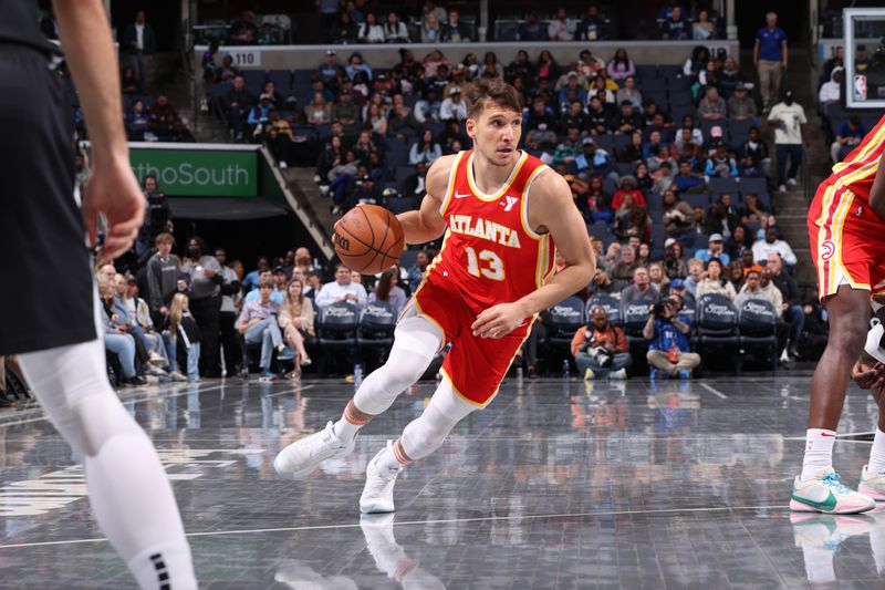 MEMPHIS, TN - MARCH 8: Bogdan Bogdanovic #13 of the Atlanta Hawks handles the ball during the game against the Memphis Grizzlies on March 8, 2024 at FedExForum in Memphis, Tennessee. NOTE TO USER: User expressly acknowledges and agrees that, by downloading and or using this photograph, User is consenting to the terms and conditions of the Getty Images License Agreement. Mandatory Copyright Notice: Copyright 2024 NBAE (Photo by Joe Murphy/NBAE via Getty Images)