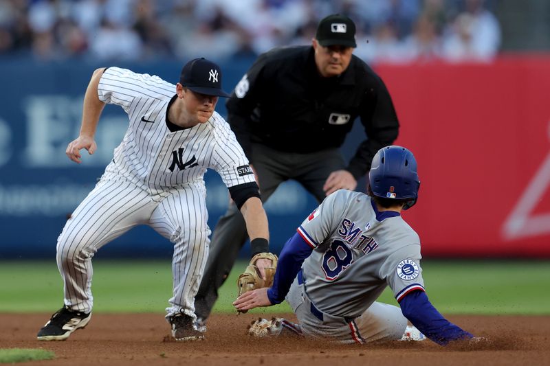 May 20, 2025; Bronx, New York, USA; New York Yankees second baseman DJ LeMahieu (26) tags out Texas Rangers shortstop Josh Smith (8) trying to steal second base during the first inning at Yankee Stadium. Mandatory Credit: Brad Penner-Imagn Images