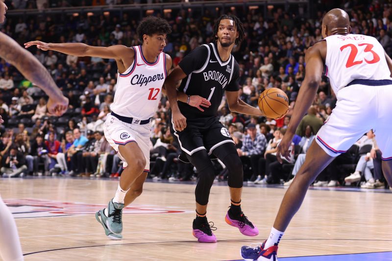 OCEANSIDE, CALIFORNIA - OCTOBER 08: Cam Christie #12 of the Los Angeles Clippers defends against Ziaire Williams #1 of the Brooklyn Nets n the third quarter at Frontwave Arena on October 08, 2024 in Oceanside, California. NOTE TO USER: User expressly acknowledges and agrees that, by downloading and or using this photograph, User is consenting to the terms and conditions of the Getty Images License Agreement. (Photo by Joe Scarnici/Getty Images)