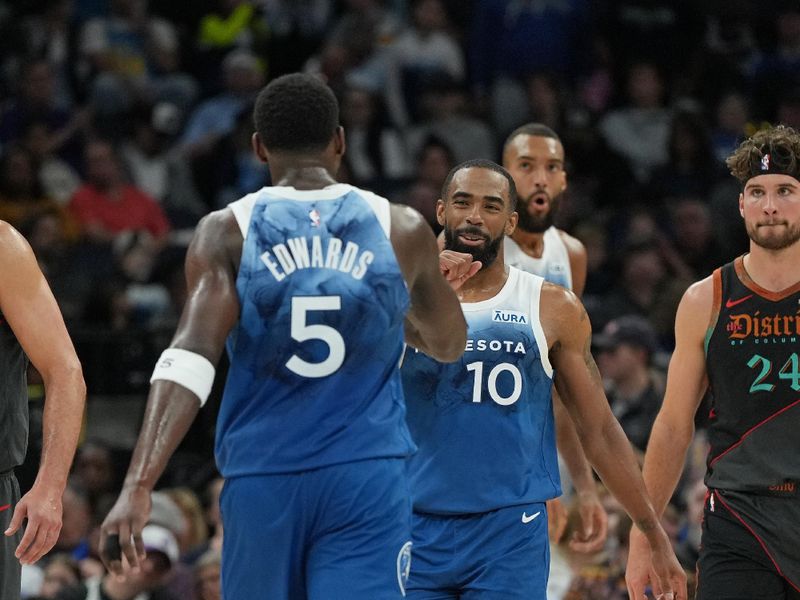 MINNEAPOLIS, MN -  APRIL 9: Anthony Edwards #5 and Mike Conley #10 of the Minnesota Timberwolves embrace during the game against the Washington Wizards on April 9, 2024 at Target Center in Minneapolis, Minnesota. NOTE TO USER: User expressly acknowledges and agrees that, by downloading and or using this Photograph, user is consenting to the terms and conditions of the Getty Images License Agreement. Mandatory Copyright Notice: Copyright 2024 NBAE (Photo by Jordan Johnson/NBAE via Getty Images)