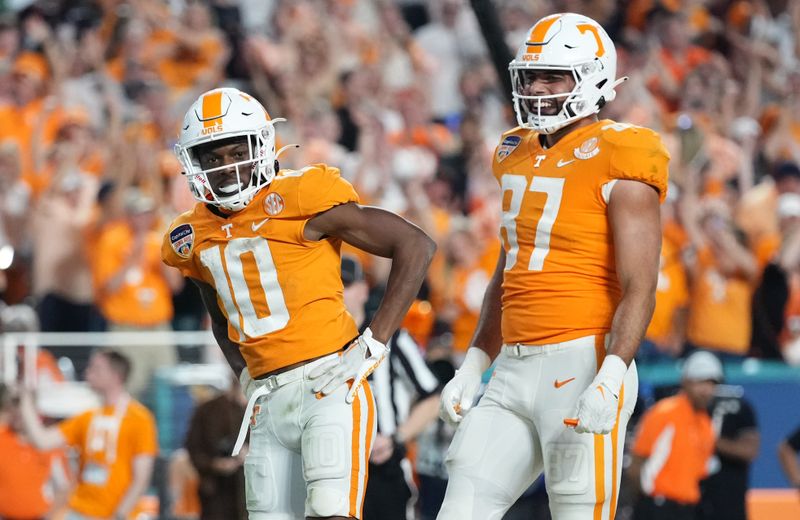 Dec 30, 2022; Miami Gardens, FL, USA; Tennessee Volunteers wide receiver Squirrel White (10) celebrates after scoring a touchdown alongside tight end Jacob Warren (87) during the second half of the 2022 Orange Bowl against the Clemson Tigers at Hard Rock Stadium. Mandatory Credit: Jasen Vinlove-USA TODAY Sports