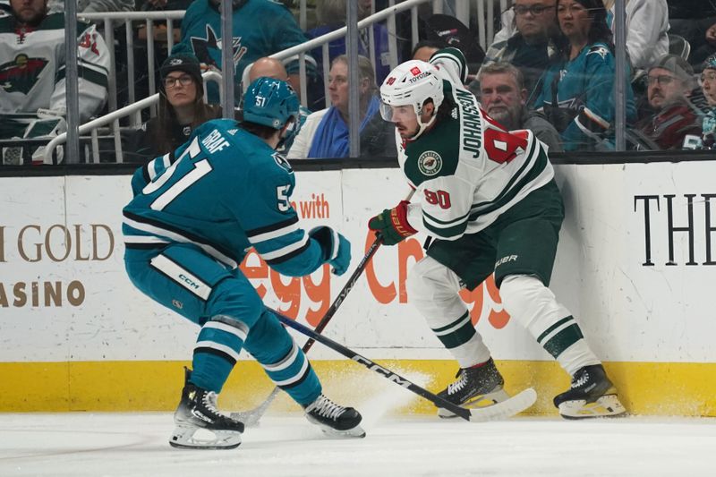 Apr 13, 2024; San Jose, California, USA; San Jose Sharks right wing Collin Graf (51) and Minnesota Wild center Marcus Johansson (90) fight for the puck during the first period at SAP Center at San Jose. Mandatory Credit: David Gonzales-USA TODAY Sports