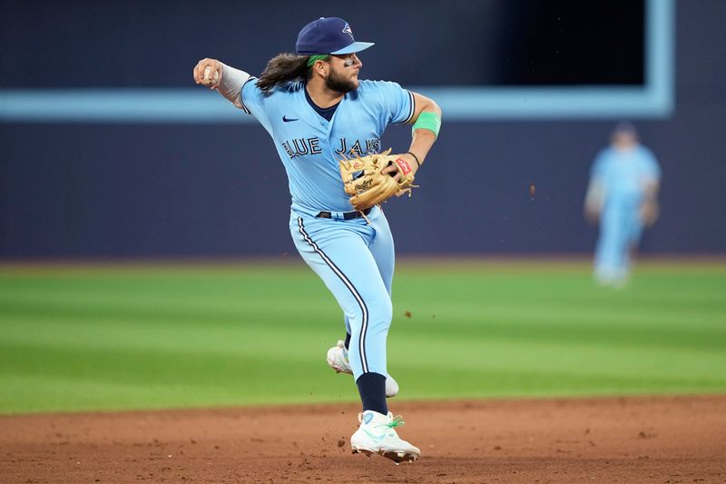 May 30, 2023; Toronto, Ontario, CAN; Toronto Blue Jays shortstop Bo Bichette (11) throws to first for the final out against the Milwaukee Brewers during the ninth inning at Rogers Centre. Mandatory Credit: John E. Sokolowski-USA TODAY Sports