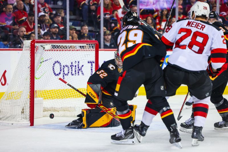 Dec 9, 2023; Calgary, Alberta, CAN; New Jersey Devils right wing Timo Meier (28) scores a goal against Calgary Flames goaltender Dustin Wolf (32) during the third period at Scotiabank Saddledome. Mandatory Credit: Sergei Belski-USA TODAY Sports