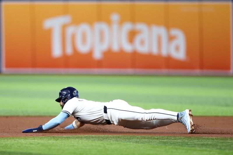 Sep 19, 2024; St. Petersburg, Florida, USA; Tampa Bay Rays third baseman Jose Caballero (7) steals second base against the Boston Red Sox in the fourth inning at Tropicana Field. Mandatory Credit: Nathan Ray Seebeck-Imagn Images