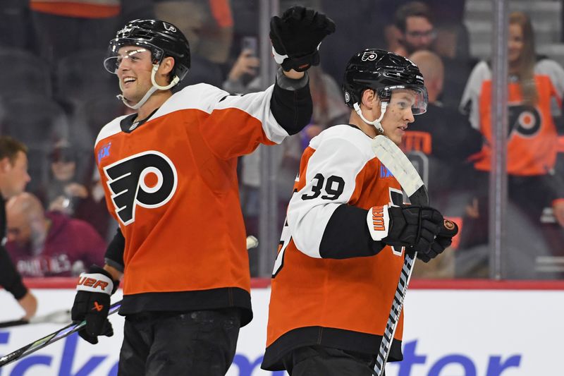 Sep 26, 2024; Philadelphia, Pennsylvania, USA; Philadelphia Flyers right wing Tyson Foerster (71) and right wing Matvei Michkov (39) celebrate win against the New York Islanders at Wells Fargo Center. Mandatory Credit: Eric Hartline-Imagn Images