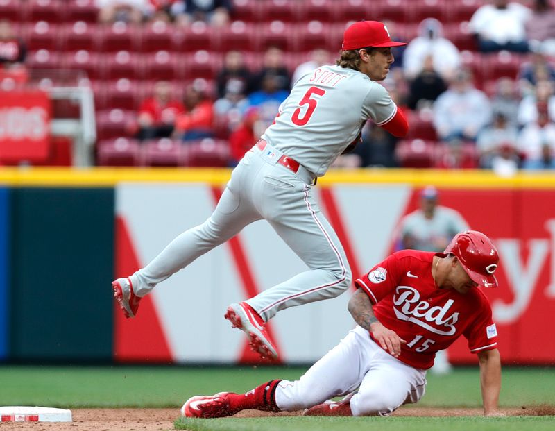 Apr 16, 2023; Cincinnati, Ohio, USA; Cincinnati Reds center fielder Nick Senzel (15) is forced out at second against Philadelphia Phillies second baseman Bryson Stott (5) during the sixth inning at Great American Ball Park. Mandatory Credit: David Kohl-USA TODAY Sports