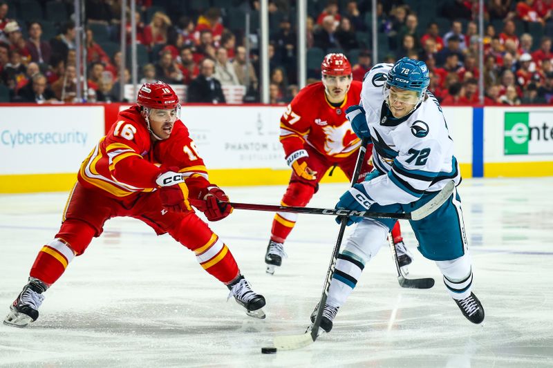 Nov 13, 2025; Calgary, Alberta, CAN; San Jose Sharks left wing William Eklund (72) controls the puck against Calgary Flames center Morgan Frost (16) during the first period at Scotiabank Saddledome. Mandatory Credit: Sergei Belski-Imagn Images