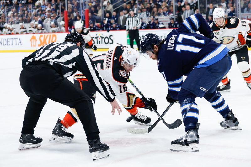 Mar 15, 2024; Winnipeg, Manitoba, CAN; Anaheim Ducks forward Ryan Strome (16) faces off against Winnipeg Jets forward Adam Lowry (17) during the first period at Canada Life Centre. Mandatory Credit: Terrence Lee-USA TODAY Sports