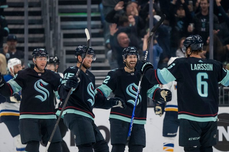 Oct 19, 2022; Seattle, Washington, USA; Seattle Kraken defenseman Adam Larsson (6) celebrates his goal with defenseman Vince Dunn (29) and forward Andre Burakovsky (95) and forward Oliver Bjorkstrand (22) during the second period against the St. Louis Blues at Climate Pledge Arena. Mandatory Credit: Stephen Brashear-USA TODAY Sports