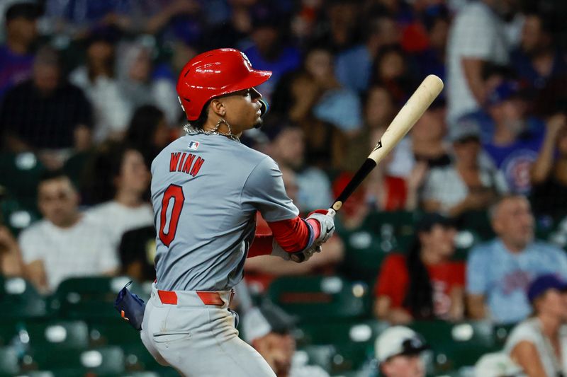 Aug 1, 2024; Chicago, Illinois, USA; St. Louis Cardinals shortstop Masyn Winn (0) hits a two-run home run against the Chicago Cubs during the seventh inning at Wrigley Field. Mandatory Credit: Kamil Krzaczynski-USA TODAY Sports