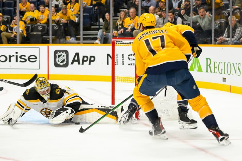 Oct 22, 2024; Nashville, Tennessee, USA;  Boston Bruins goaltender Jeremy Swayman (1) blocks the rebound shot of Nashville Predators center Mark Jankowski (17) during the first period at Bridgestone Arena. Mandatory Credit: Steve Roberts-Imagn Images