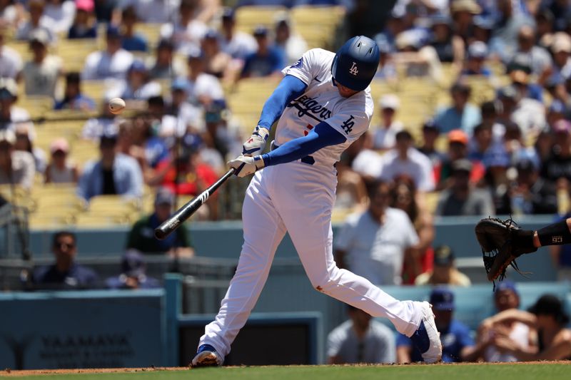 Aug 11, 2024; Los Angeles, California, USA;  Los Angeles Dodgers first baseman Freddie Freeman (5) hits a double during the first inning against the Pittsburgh Pirates at Dodger Stadium. Mandatory Credit: Kiyoshi Mio-USA TODAY Sports