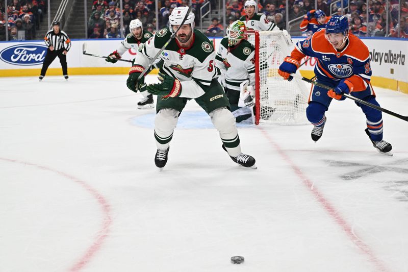 Dec 2, 2025; Edmonton, Alberta, CAN;   Minnesota Wild defenseman  Jake Middleton (5) and Edmonton Oilers center Ryan Nugent-Hopkins (93) battle in front of Minnesota Wild goalie Jesper Wallstedt (30) during the third period at Rogers Place. Mandatory Credit: Walter Tychnowicz-Imagn Images