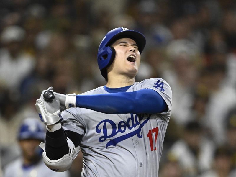 Oct 9, 2024; San Diego, California, USA; Los Angeles Dodgers designated hitter Shohei Ohtani (17) reacts after being hit with a foul ball  in the eighth inning against the San Diego Padres during game four of the NLDS for the 2024 MLB Playoffs at Petco Park.  Mandatory Credit: Denis Poroy-Imagn Images