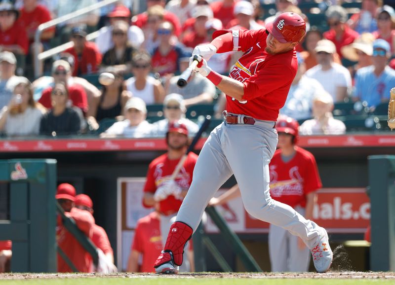 Feb 26, 2023; Jupiter, Florida, USA; St. Louis Cardinals second baseman Nolan Gorman (16) singles in the first inning against the Miami Marlins at Roger Dean Stadium. Mandatory Credit: Rhona Wise-USA TODAY Sports