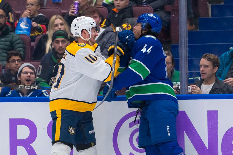 Nov 17, 2024; Vancouver, British Columbia, CAN; Nashville Predators forward Colton Sissons (10) checks Vancouver Canucks forward Kiefer Sherwood (44) during the second period at Rogers Arena. Mandatory Credit: Bob Frid-Imagn Images