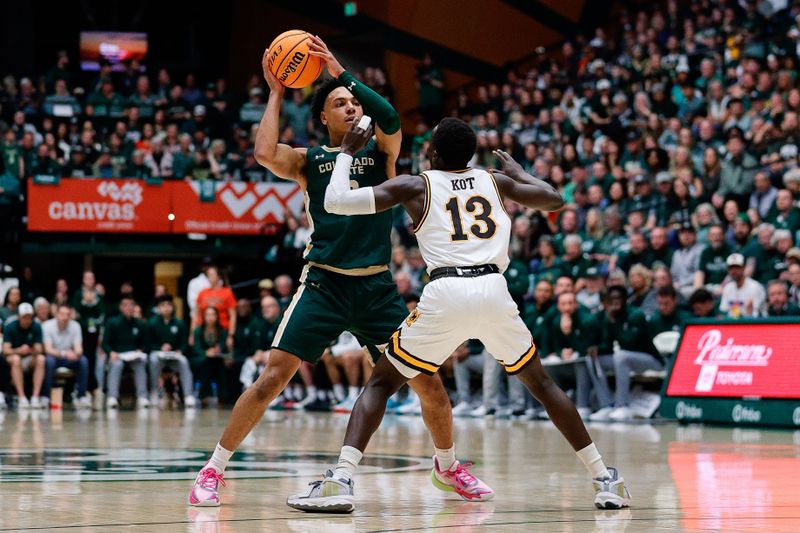 Mar 2, 2024; Fort Collins, Colorado, USA; Colorado State Rams guard Josiah Strong (3) controls the ball as Wyoming Cowboys guard Akuel Kot (13) guards in the first half at Moby Arena. Mandatory Credit: Isaiah J. Downing-USA TODAY Sports