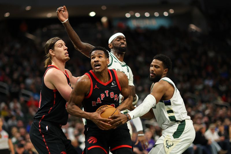 MILWAUKEE, WISCONSIN - APRIL 05: Ochai Agbaji #30 of the Toronto Raptors drives to the basket against Malik Beasley #5 of the Milwaukee Bucks during the first half of a game at Fiserv Forum on April 05, 2024 in Milwaukee, Wisconsin. NOTE TO USER: User expressly acknowledges and agrees that, by downloading and or using this photograph, User is consenting to the terms and conditions of the Getty Images License Agreement. (Photo by Stacy Revere/Getty Images)