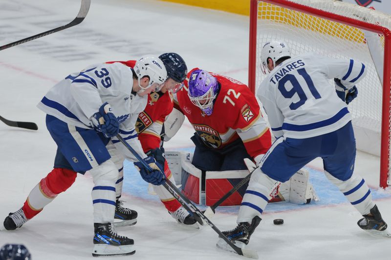 Nov 27, 2024; Sunrise, Florida, USA; Florida Panthers goaltender Sergei Bobrovsky (72) defends his net against Toronto Maple Leafs center John Tavares (91) and center Fraser Minten (39) during the third period at Amerant Bank Arena. Mandatory Credit: Sam Navarro-Imagn Images